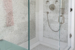 Frameless glass shower doors with custom bench